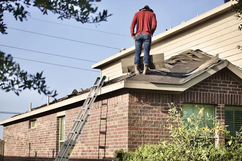 Professional roofer working on a residential roof in Congo